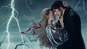 Jacob Elordi and Margot Robbie embrace against the backdrop of a lightning storm in a "Wuthering Heights" poster (Warner Bros.)
