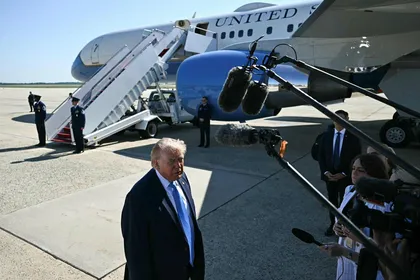 U.S. President Donald Trump speaks to reporters before boarding Air Force One at Joint Base Andrews, Maryland, Monday.