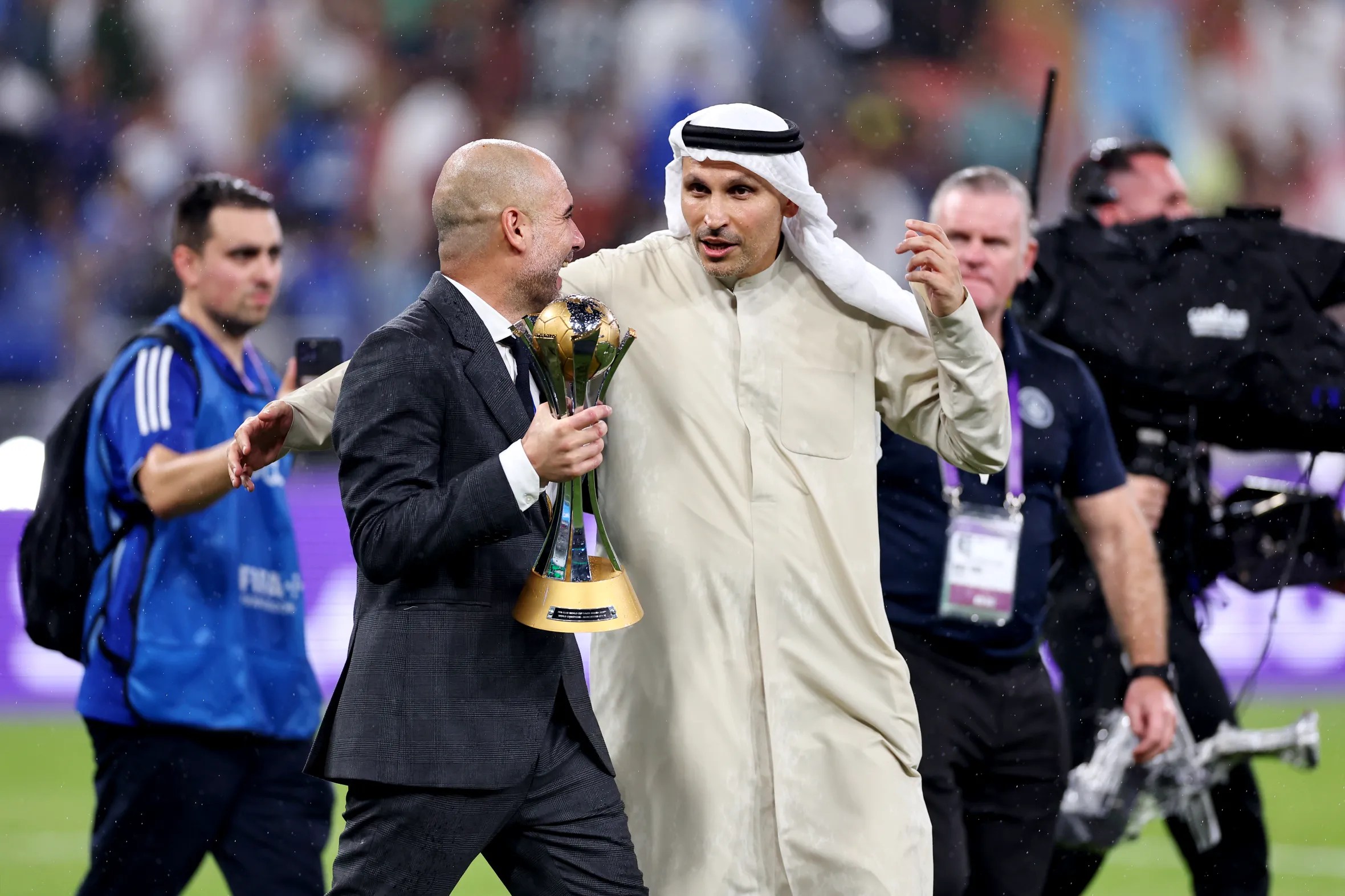Pep Guardiola and Khaldoon Al Mubarak celebrating with the FIFA Club World Cup Trophy.