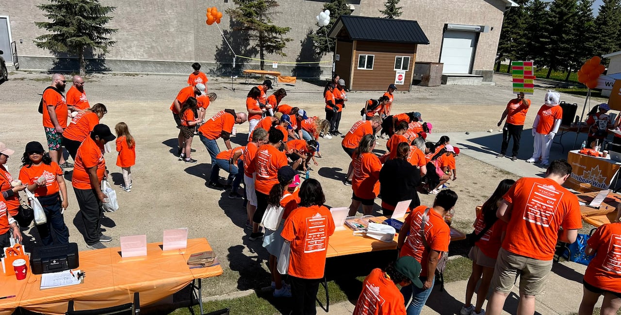 People in orange shirts