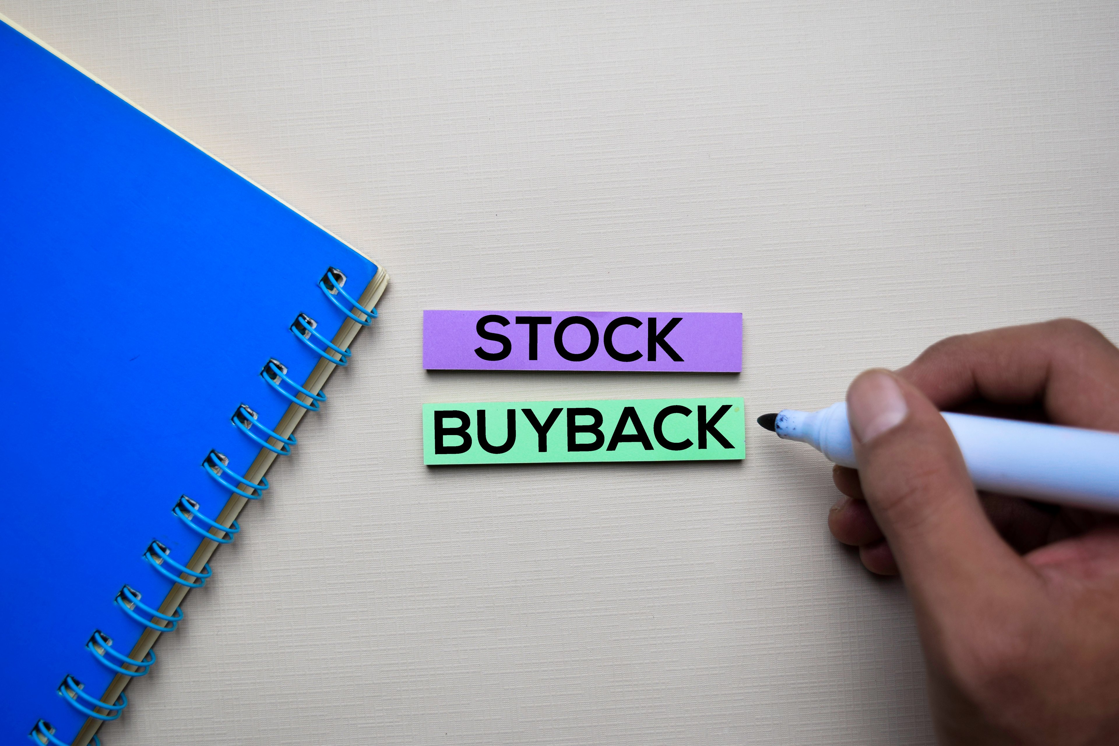 Stock buyback written in marker on a notepad.