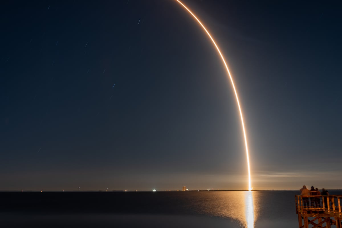 A rocket launch over the water.
