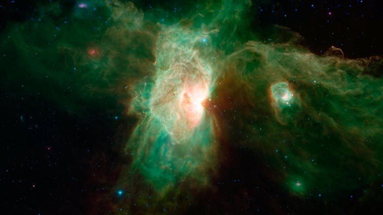 Great green and yellow wispy cloud stretching irregularly in space from a bright center.