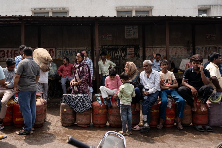 Indian buyers queue to refill their empty liquefied petroleum gas (LPG) cylinders near a gas agency office in Noida, on the outskirts of New Delhi, India, on March 27.