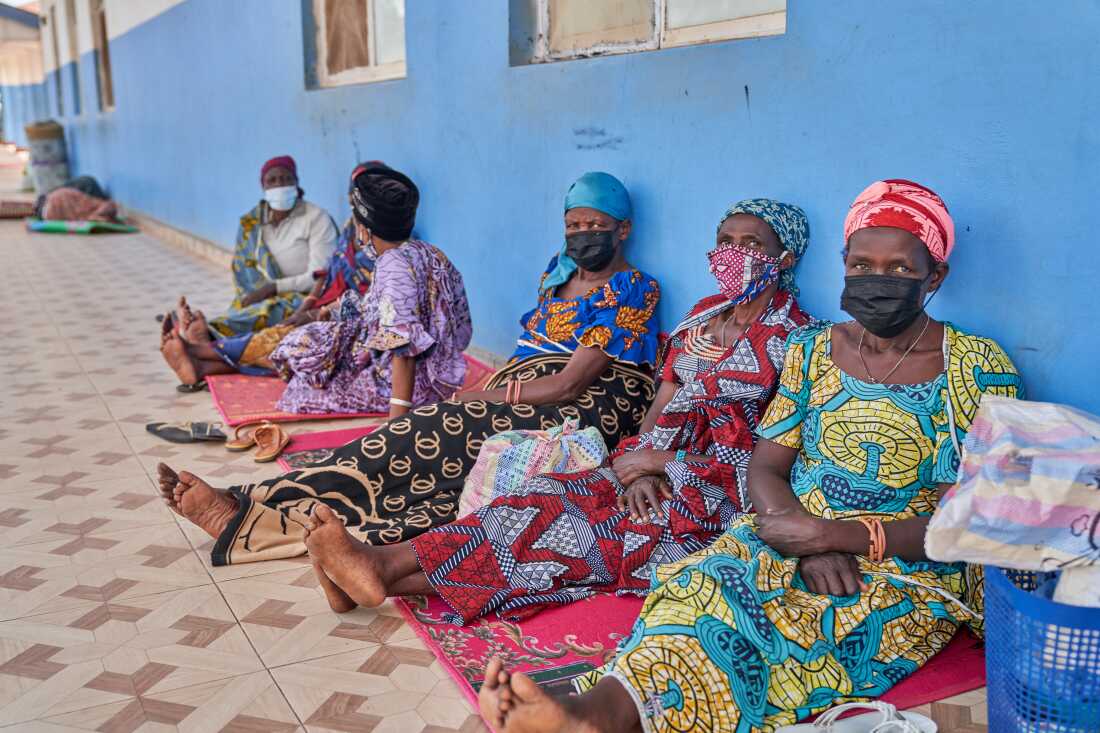 People in protective masks wait in the corridor of a hospital in Bunia, Congo, Tuesday, May 19, 2026.