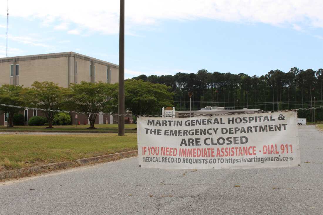 A weathered sign hangs across the drive to the shuttered Martin General Hospital in Williamston, North Carolina. The hospital, the only one in Martin County, closed abruptly in August 2023.