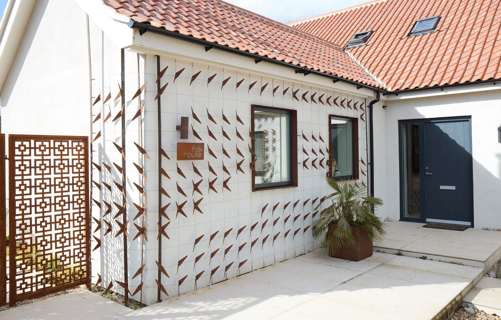 Trellises With Cor-Ten Cutouts Wrap the Facade of This Renovated U.K. Home