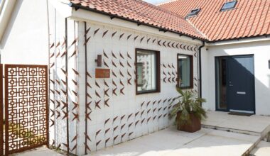 Trellises With Cor-Ten Cutouts Wrap the Facade of This Renovated U.K. Home