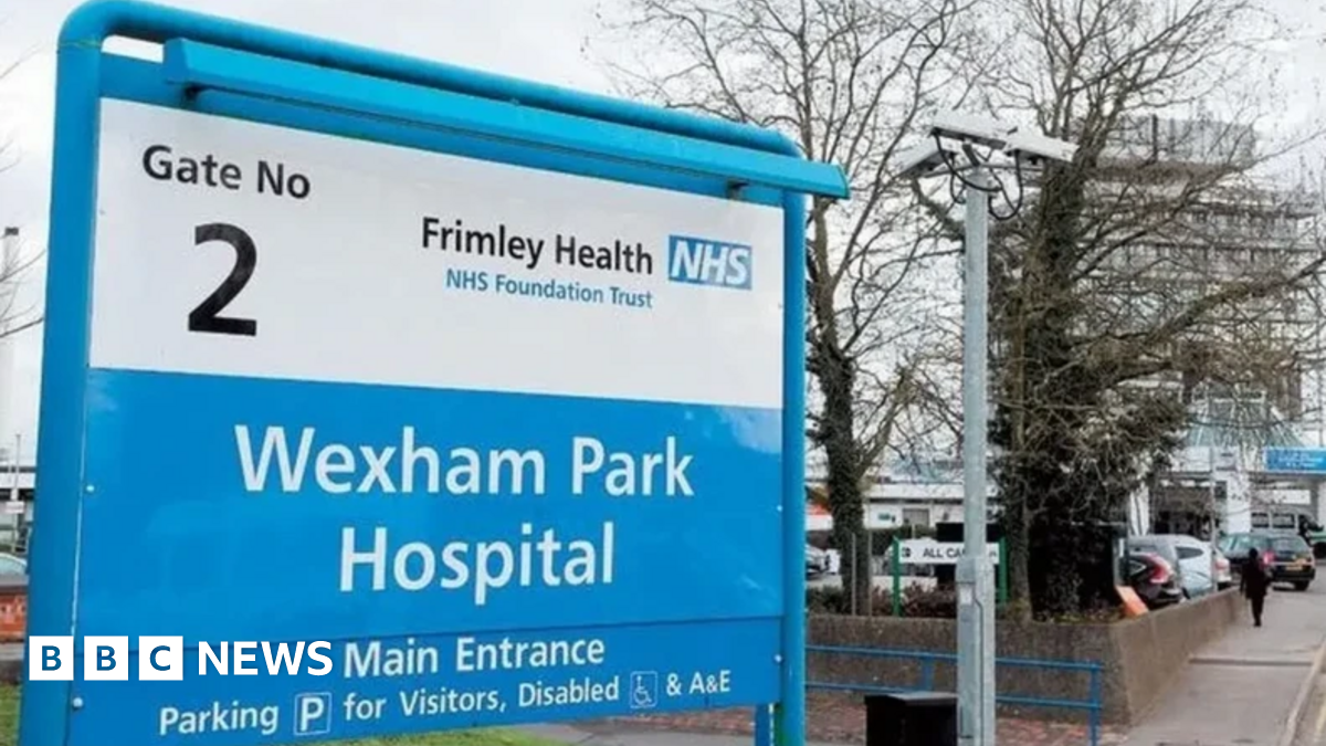 A sign outside Wexham Park Hospital and a building to the right of it.