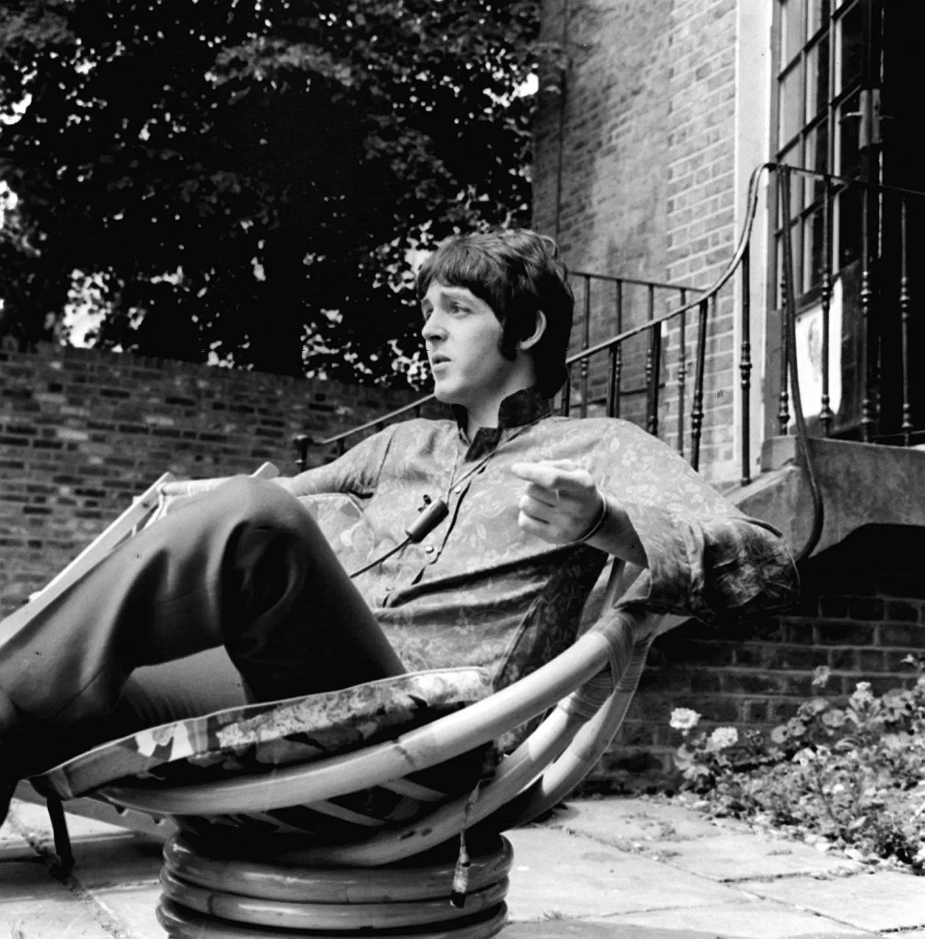 Paul McCartney relaxing in a chair in his garden.