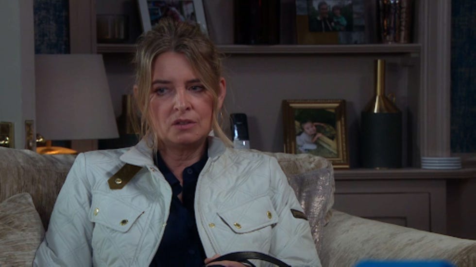 emmerdale charity dingle person seated on a couch in a living room setting