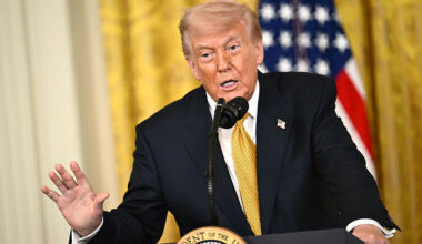 Donald Trump speaking at a podium.