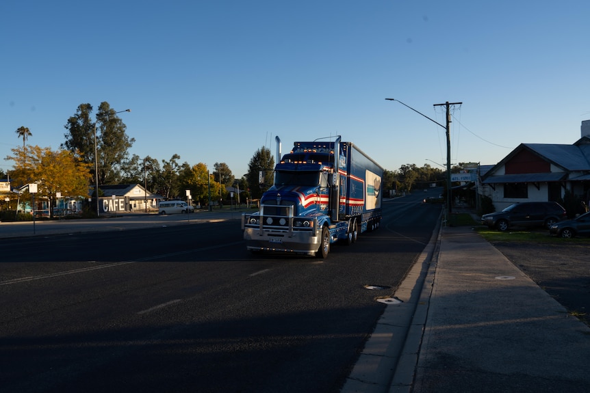 A truck is parked on the street in a truck changeover yard in the late afternoon.