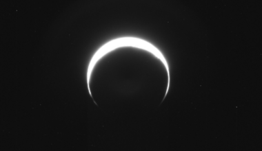 Mars as a bright crescent as seen by the Psyche spacecraft as it heads for a Red Planet rendezvous