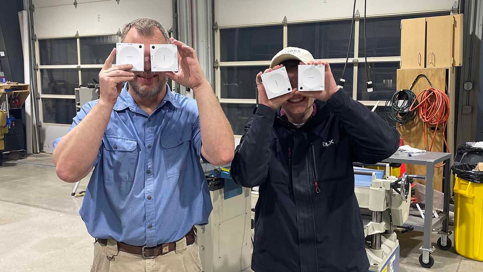 Greg Locke left with Power Theory founder Luke Macy hold sensors over their eyes.