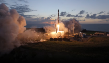 a black and white rocket launches into a dusky, cloudy sky