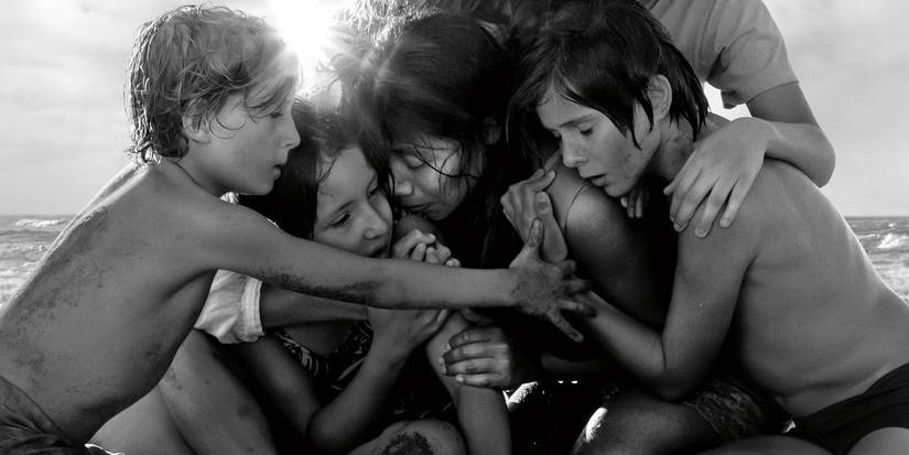 Roma's family embrace on the beach