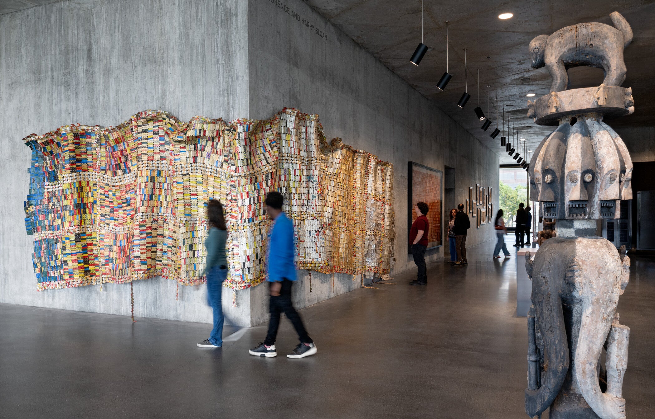Visitors in the David Geffen Galleries with El Anatsui’s Fading Scroll, 2007, Los Angeles County Museum of Art, Los Angeles County Museum of Art and the Fowler Museum, UCLA, purchased jointly with funds provided by The Broad Art Foundation, Phil Berg, Mary and Robert Looker, and Margaret Pexton Murray, © El Anatsui, photo © Museum Associates/LACMA, by Charles Powers