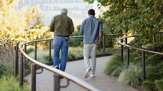 Two friends walking on a winding path at the High Line park in Manhattan.