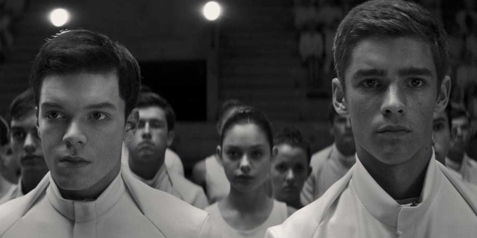 A group of teenagers standing in a crowd and looking ahead in 'The Giver'