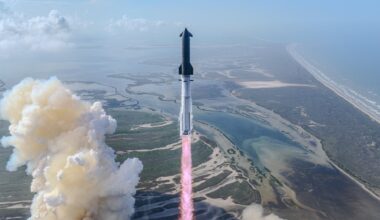 a large silver rocket launches above a plume of fire