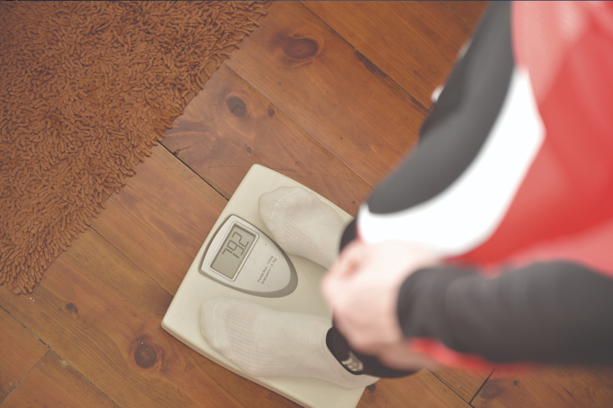 Cyclist stands on the on scales