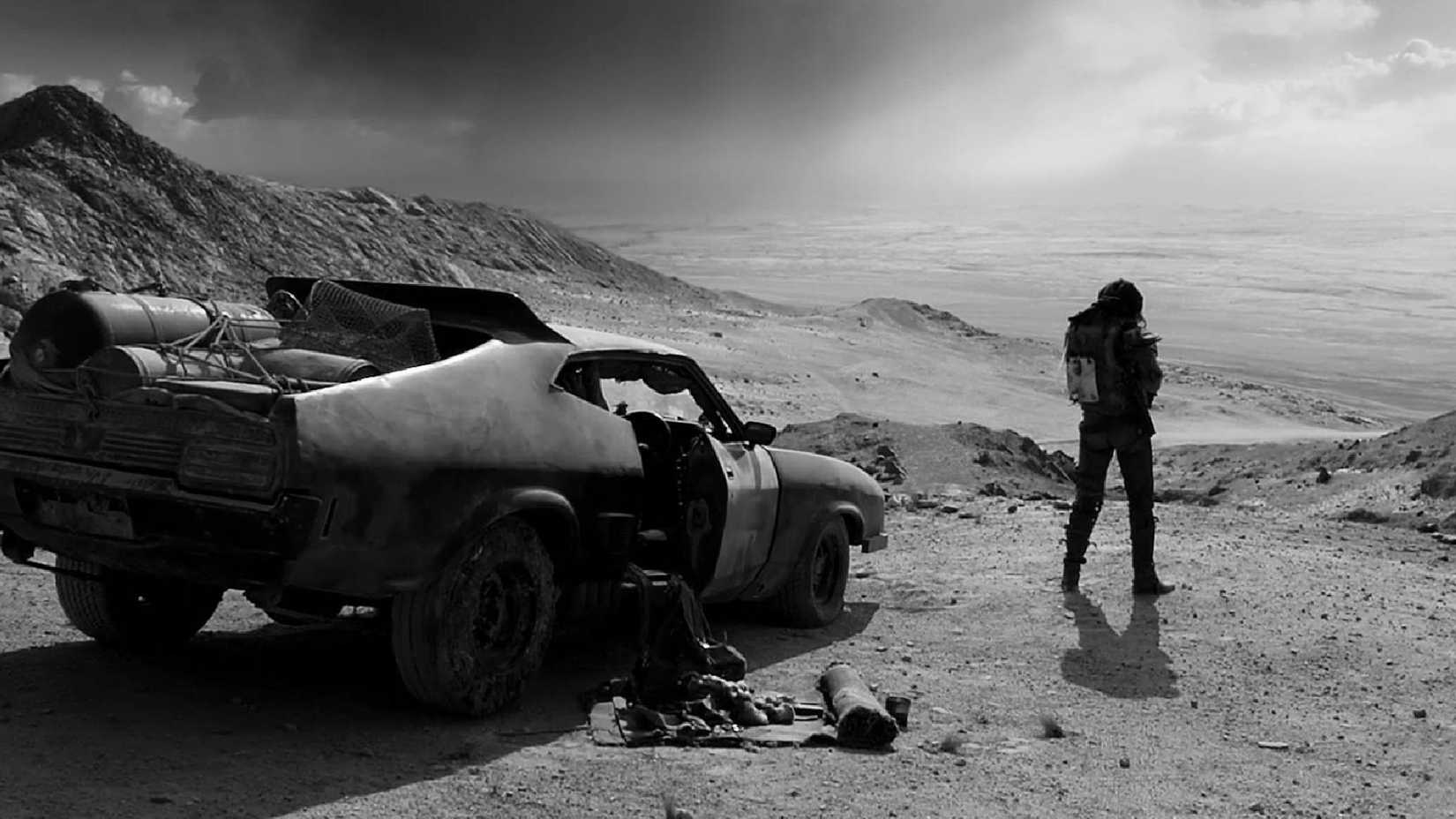 a still from mad max fury road black and chrome