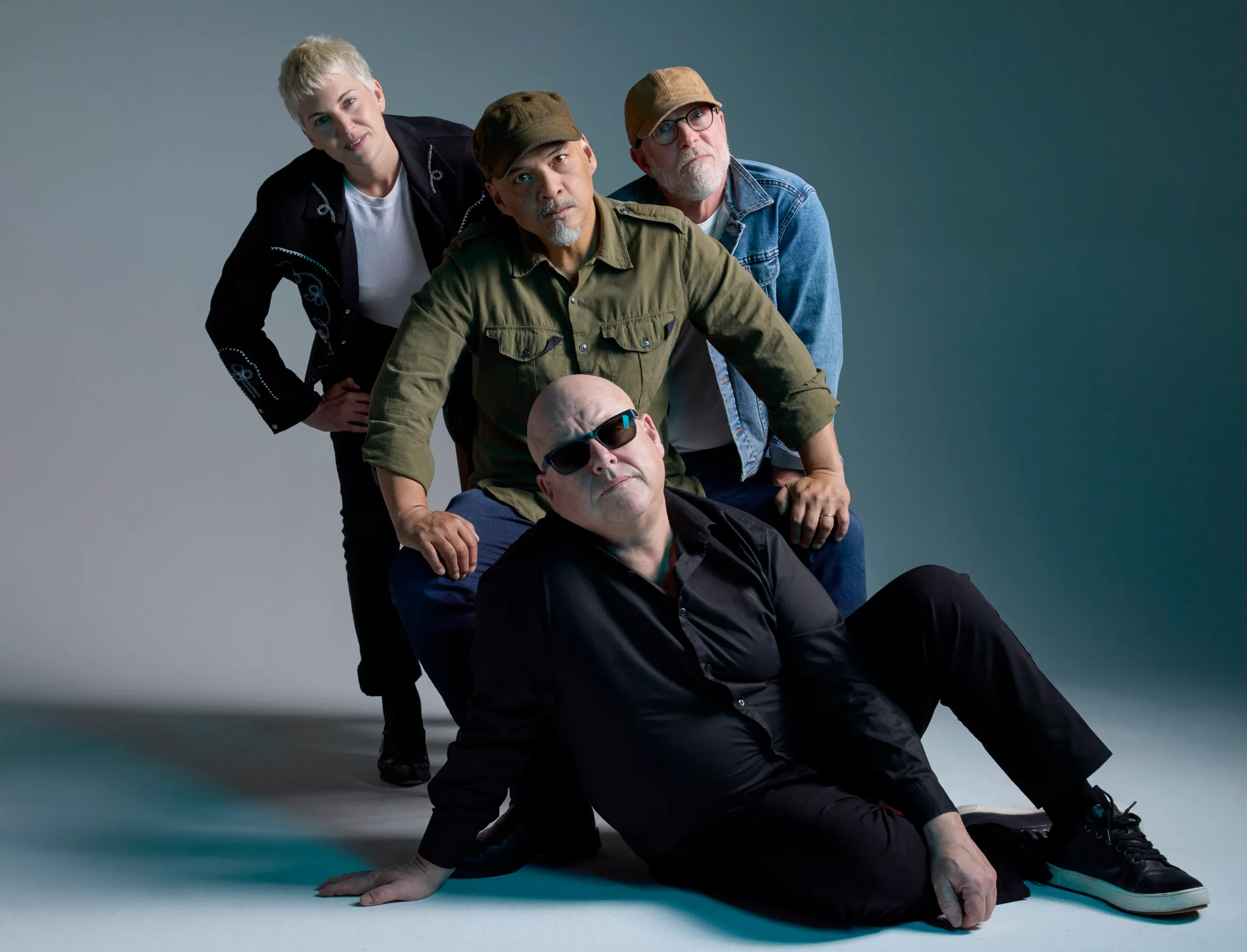 The four members of the band Pixies in a studio shot.