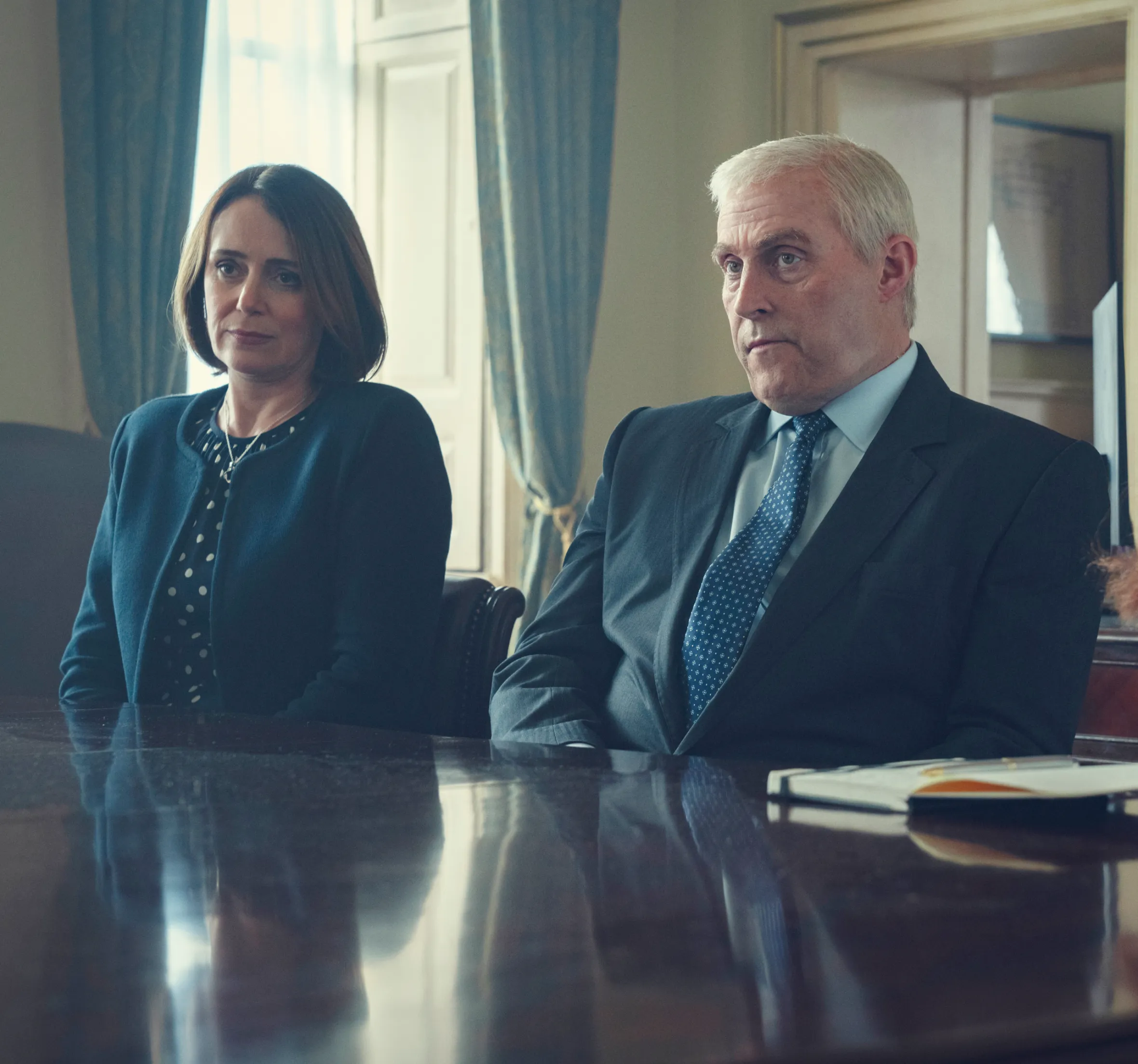 Film still from Scoop, featuring Keeley Hawes as Amanda Thirsk, Rufus Sewell as Prince Andrew, and Charity Wakefield as Princess Beatrice.