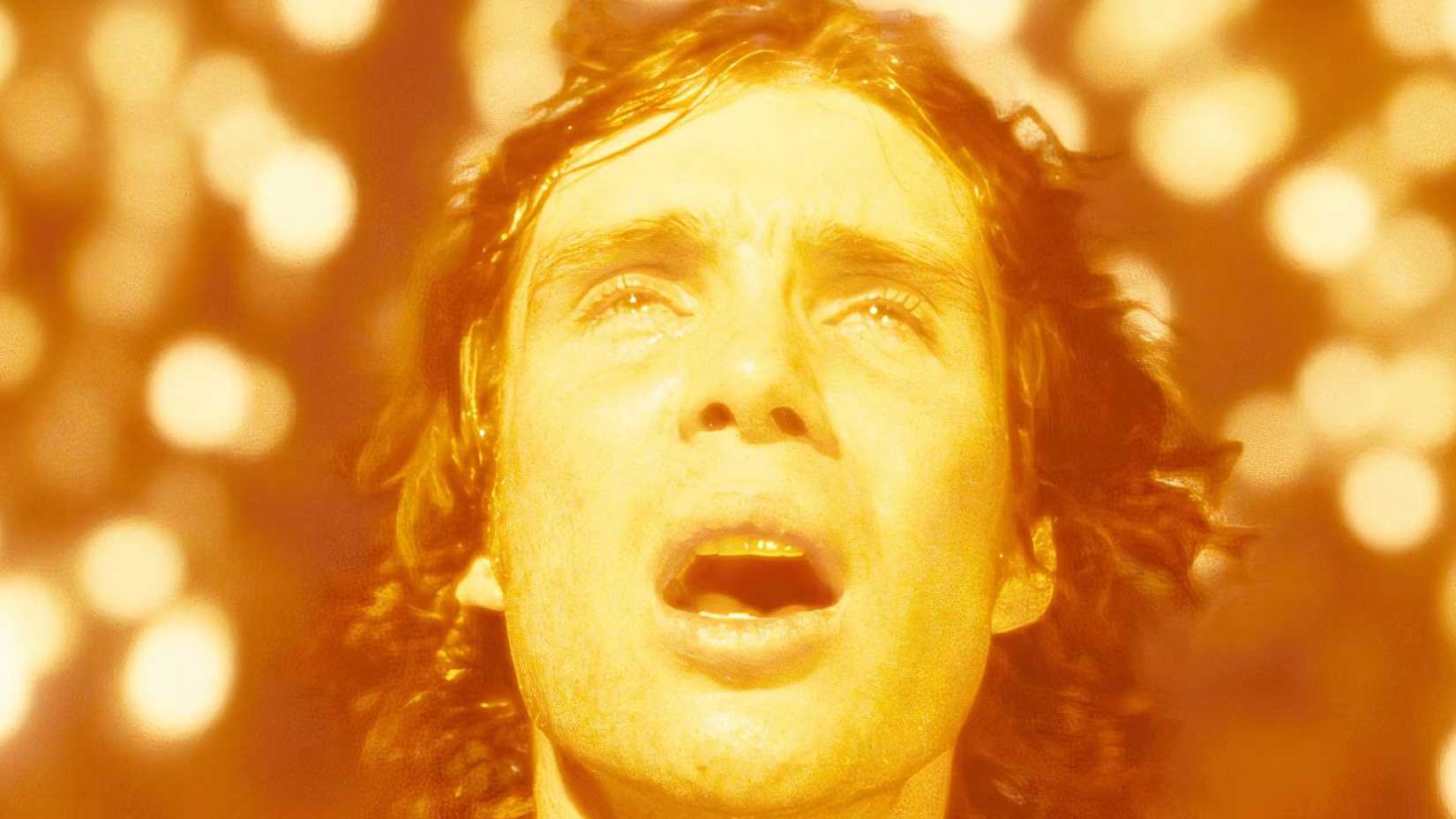Cillian Murphy with his mouth agape surrounded by sparks in Sunshine