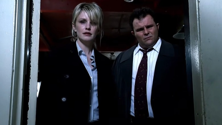 Lilly Rush standing in doorway next to Nick Vera