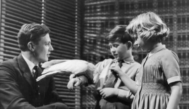 Prince Charles and Princess Anne meet naturalist David Attenborough at Lime Grove Studios on the 4th January, 1958. The young royals are introduced to a cockatoo captured on Attenborough