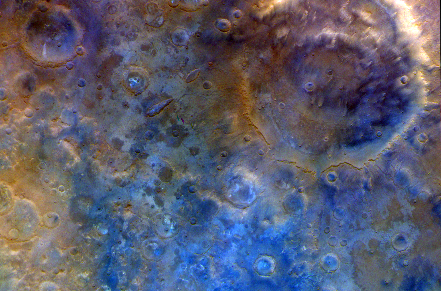 In this representative color image, Mars' surface appears in shades of red, orange, and blue. At right is a double-ring crater called Huygens. To