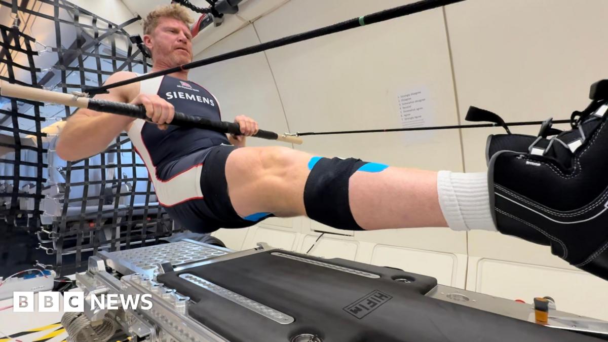 Matthew Wells, olympic medalist, floats as he rows on a parabolic flight.
