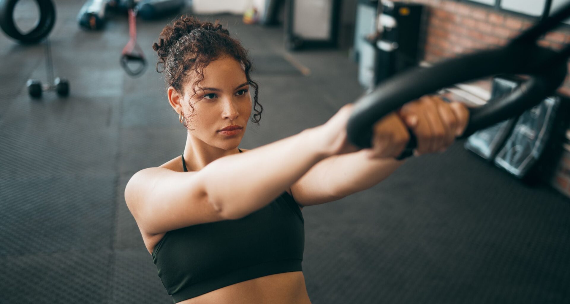Fitness woman, gymnast ring and woman doing exercise workout , strength training and body wellness routine. Strong sports female or athlete with dip rings for power, self care and a healthy lifestyle