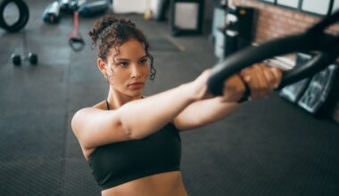 Fitness woman, gymnast ring and woman doing exercise workout , strength training and body wellness routine. Strong sports female or athlete with dip rings for power, self care and a healthy lifestyle