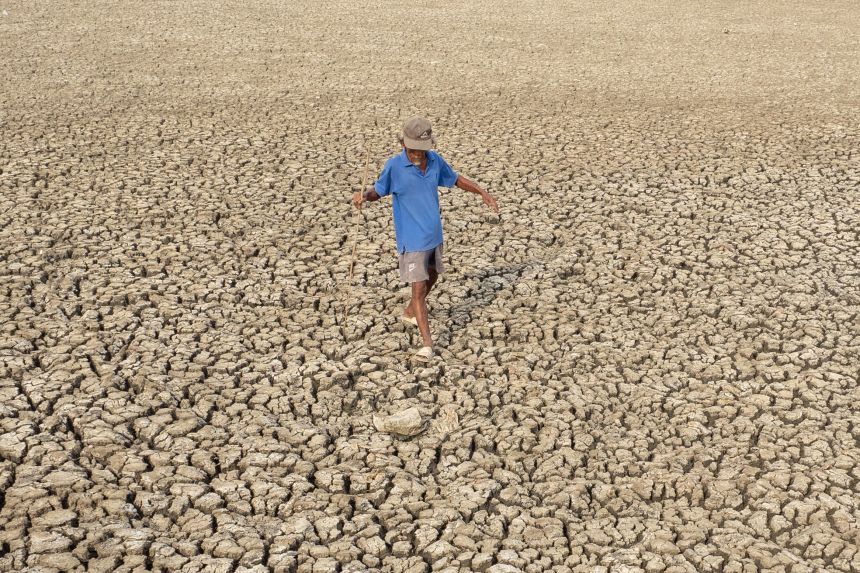 A resident observes the condition of a receding fishpond due to the El Nino phenomenon in Tangerang Regency, Indonesia, on October 17, 2023.