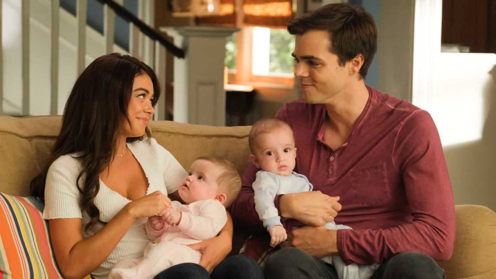 Haley and Dylan holding twin babies in Modern Family.