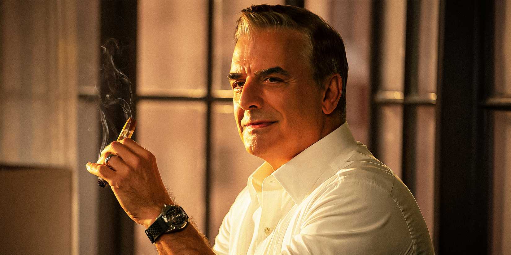 Chris Noth as Mr. Big smoking a cigar in And Just Like That season 1
