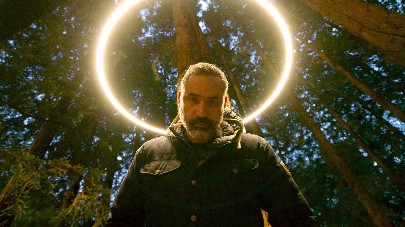 A man standing in front of a ring of light in Hulu's Devs.