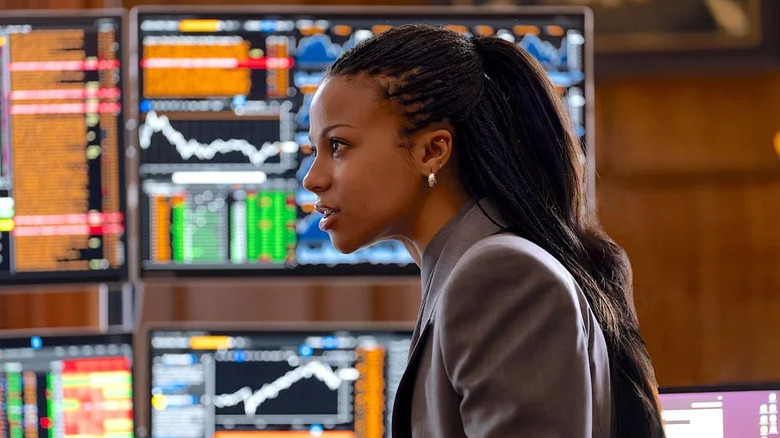 Myha'la as Harper sitting in front of several lit-up computer screens in Industry