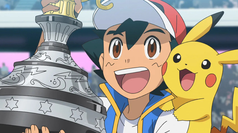 Ash Ketchum holding a trophy and smiling with Pikachu in the Pokemon anime