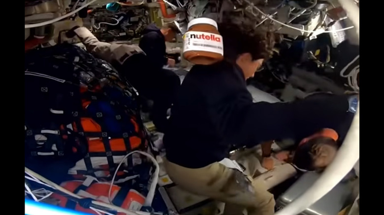 A jar of Nutella floats past Artemis astronaut Christina Koch on their voyage to the Moon