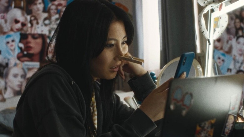 Shirley Chen's Joan takes a selfie while attempting to change her features in Slanted