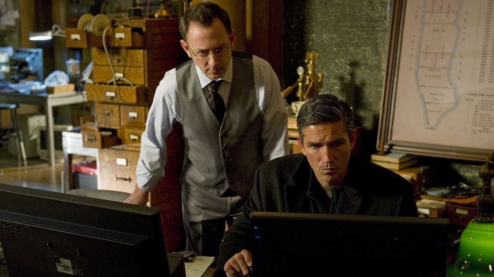 Reese (Jim Caviezel) and Finch (Michael Emerson) look at a computer in Person of Interest.