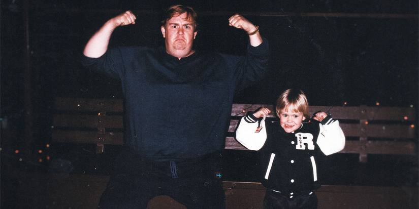 Photograph of John Candy and a child flexing their biceps from John Candy: I Like Me