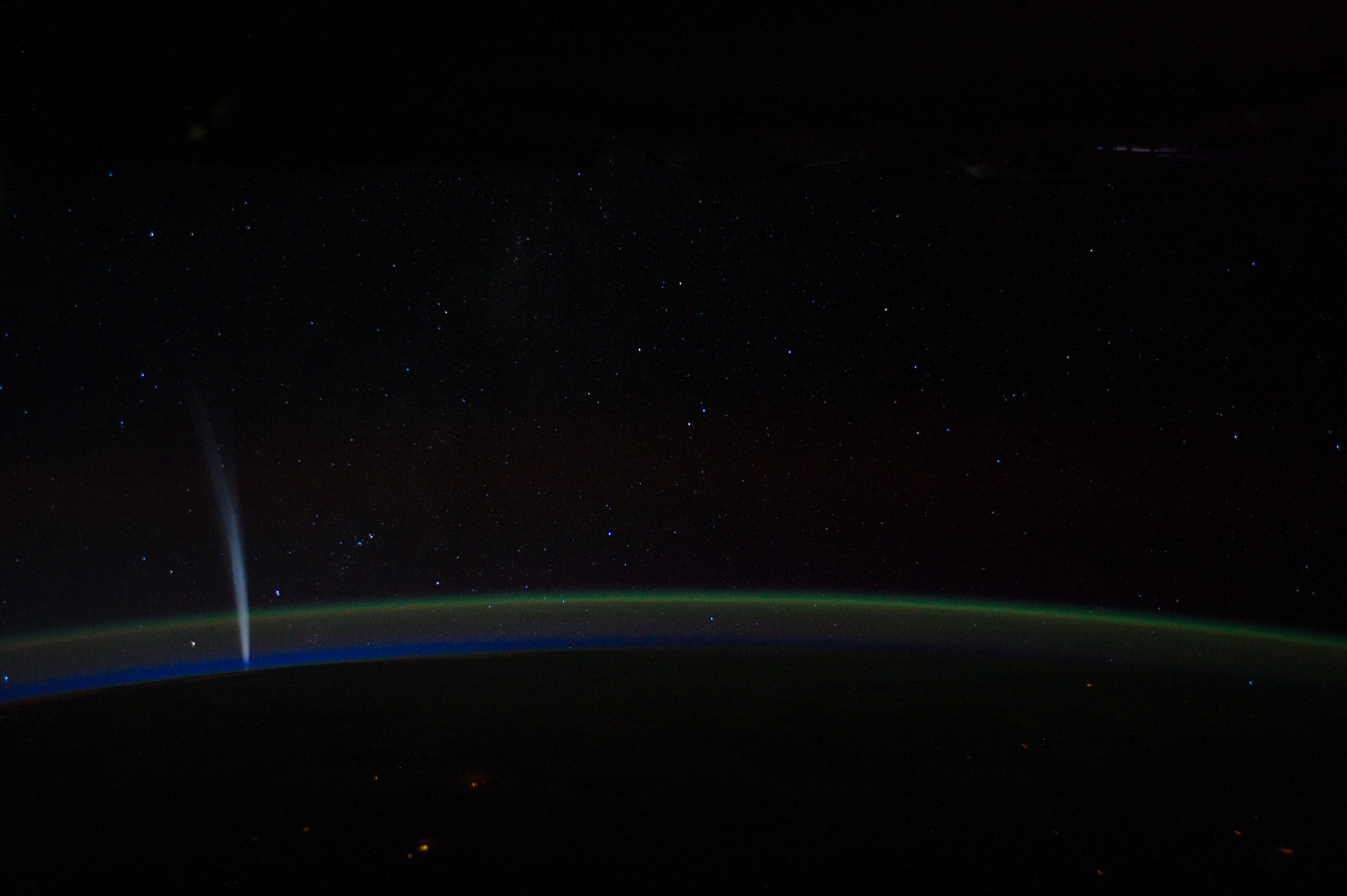 Comet Lovejoy is visible near Earth’s horizon in this nighttime image photographed by NASA astronaut Dan Burbank, Expedition 30 commander, onboard the International Space Station on Dec. 21, 2011.