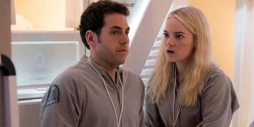 Jonah Hill and Emma Stone having a talk in matching jumpsuits in the 2018 Netflix miniseries Maniac.