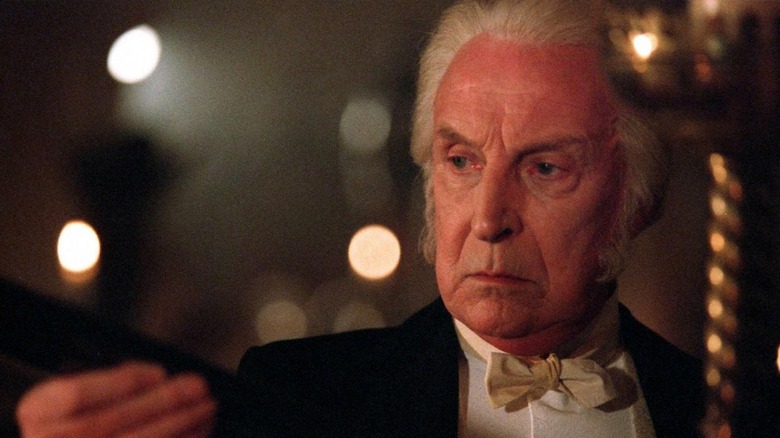 Joseph Bell (Ian Richardson) examines something in his right hand in Murder Rooms: Mysteries of the Real Sherlock Holmes