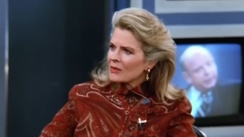 Candice Bergen as Murphy Brown sitting in front of TV in Murphy Brown